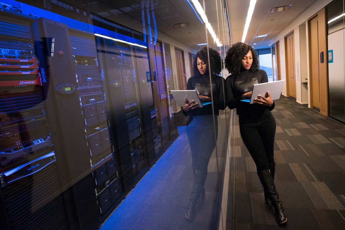 A professional reviewing data on a tablet in a technology environment