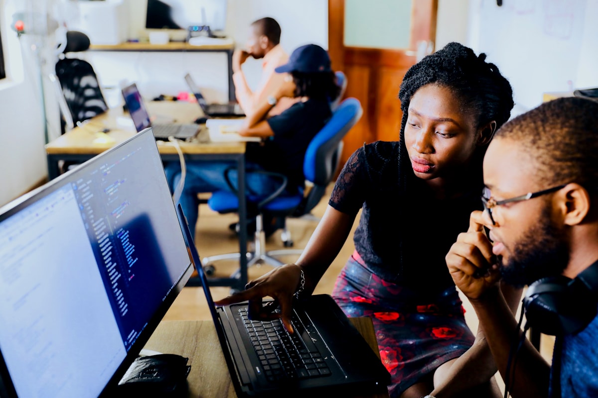 Two colleagues reviewing data and insights together on a laptop